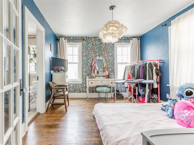 bedroom with an inviting chandelier and hardwood / wood-style flooring