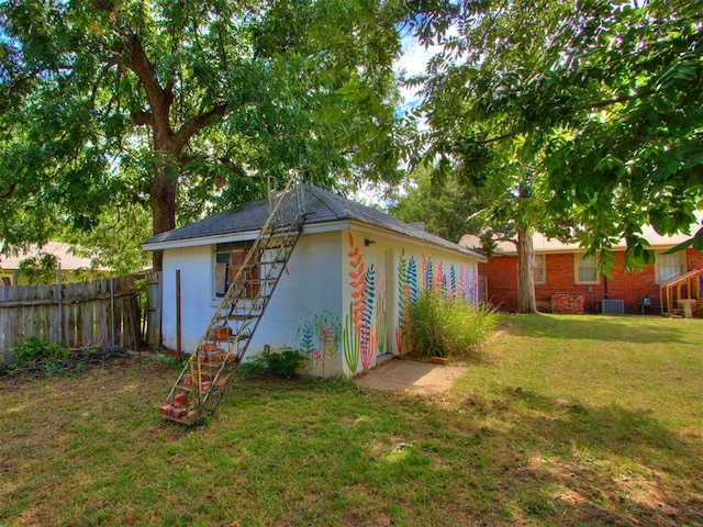 view of outbuilding featuring a lawn