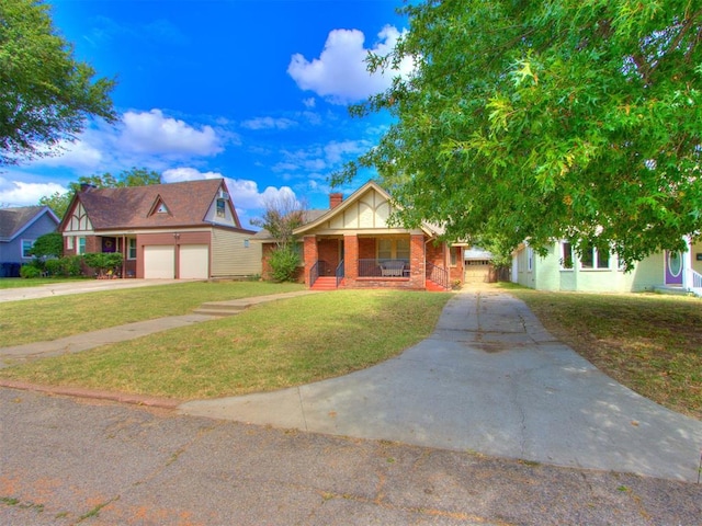 view of front of home featuring a front yard, a porch, and a garage