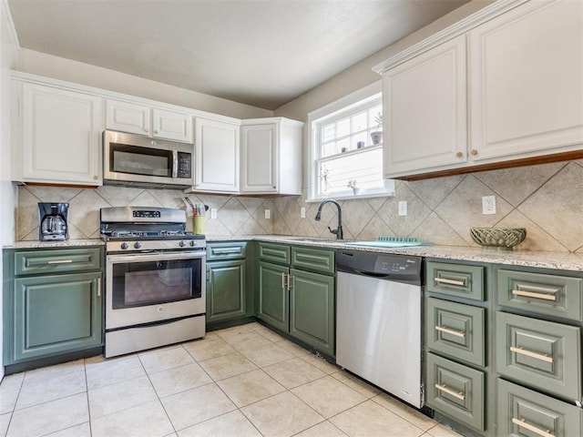 2045 NW 21st St, Oklahoma City, OK 73106 - kitchen with appliances with stainless steel finishes, green cabinetry, a sink, and white cabinetry