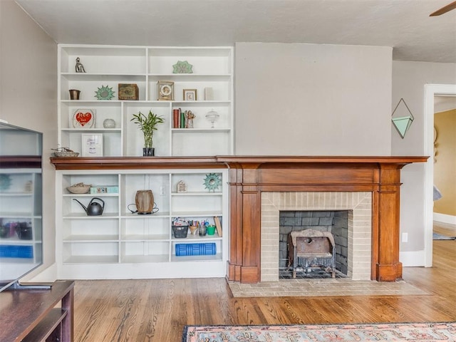 2045 NW 21st St, Oklahoma City, OK 73106 - unfurnished living room with wood finished floors, a brick fireplace, and baseboards