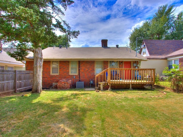 2045 NW 21st St, Oklahoma City, OK 73106 - rear view of house with a wooden deck, brick siding, and central AC unit