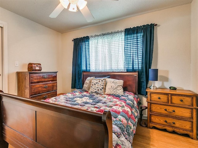 bedroom with ceiling fan and wood-type flooring