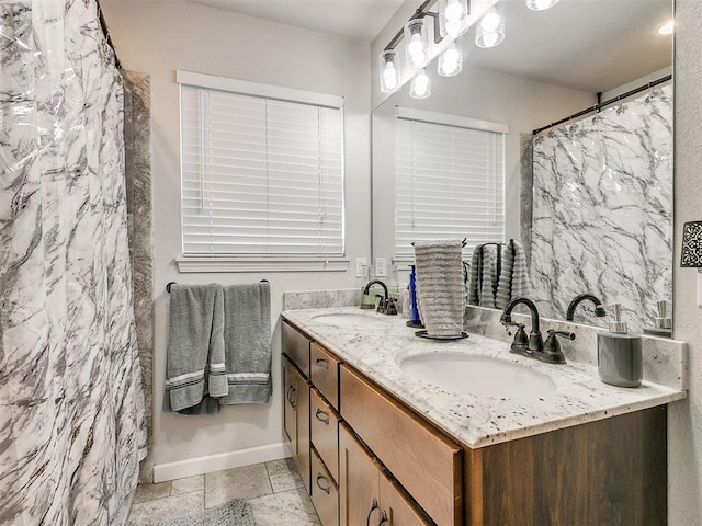 bathroom featuring vanity and curtained shower