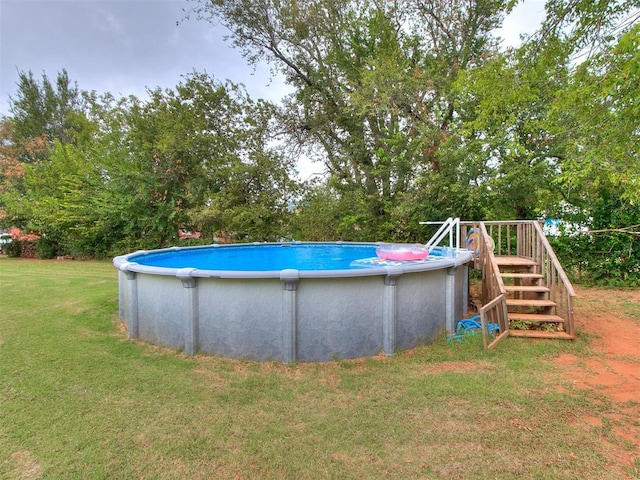 view of pool featuring a yard