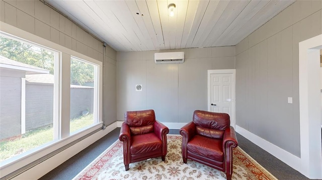 living area with a healthy amount of sunlight, wood ceiling, and a wall mounted AC