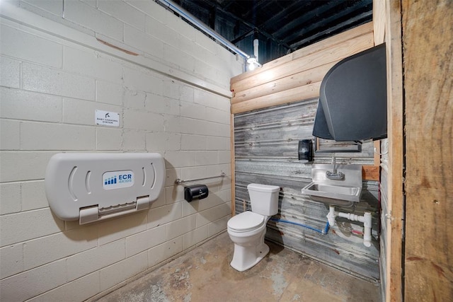 bathroom featuring concrete flooring and toilet