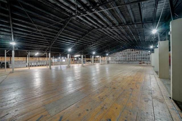 interior space with hardwood / wood-style flooring and lofted ceiling