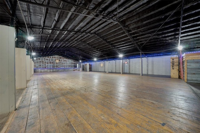 empty room featuring hardwood / wood-style flooring and lofted ceiling