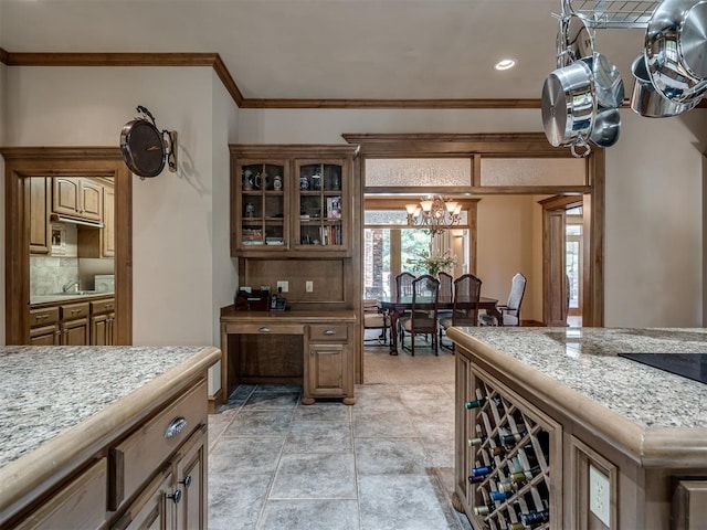 kitchen with backsplash, an inviting chandelier, and crown molding