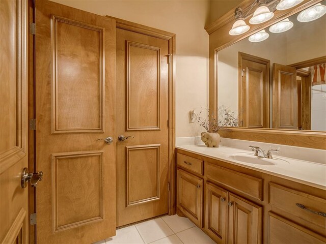 bathroom with tile patterned flooring and vanity