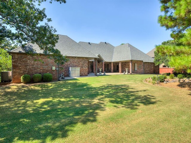 single story home with central AC and a front lawn