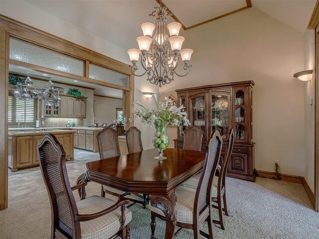 dining room featuring light carpet, high vaulted ceiling, and an inviting chandelier