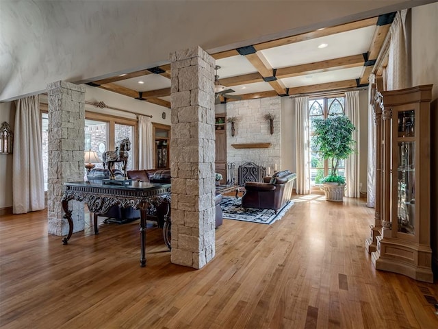 interior space with beamed ceiling, decorative columns, and hardwood / wood-style flooring