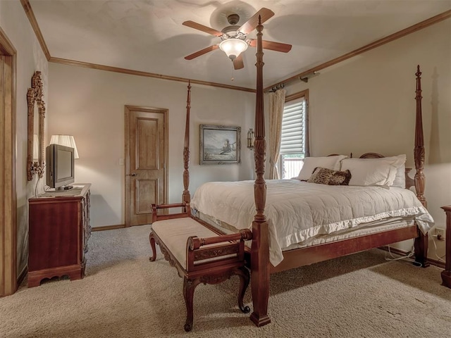 carpeted bedroom featuring ceiling fan and ornamental molding