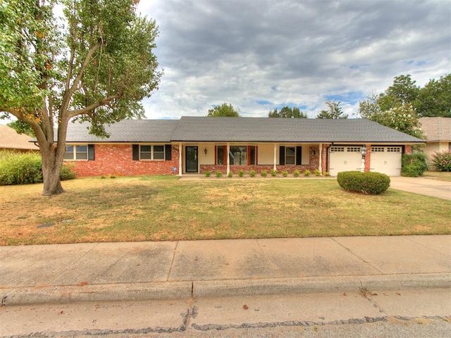 ranch-style home featuring a garage and a front yard