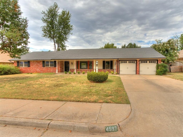 ranch-style home with a porch, a garage, and a front yard