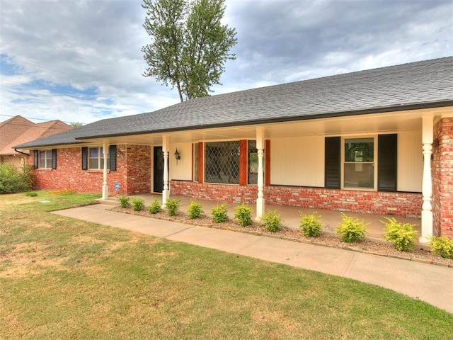 4997 NW 30th Pl, Oklahoma City, OK 73122 - single story home with brick siding, a front lawn, and a shingled roof