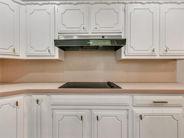 4997 NW 30th Pl, Oklahoma City, OK 73122 - kitchen featuring range hood, black electric stovetop, white cabinets, and light countertops