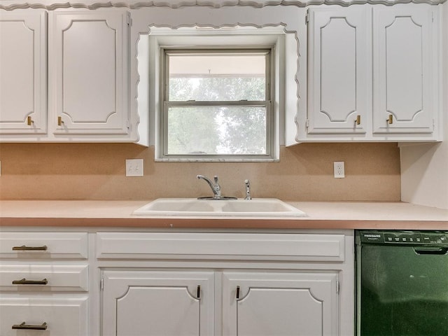 kitchen featuring sink, white cabinetry, and black dishwasher