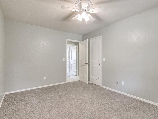 unfurnished room featuring ceiling fan and light carpet