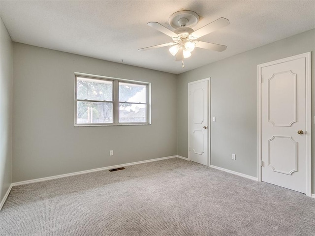 spare room with carpet flooring and ceiling fan