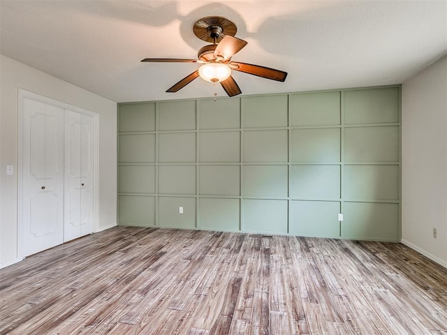 unfurnished bedroom featuring light wood-type flooring and ceiling fan