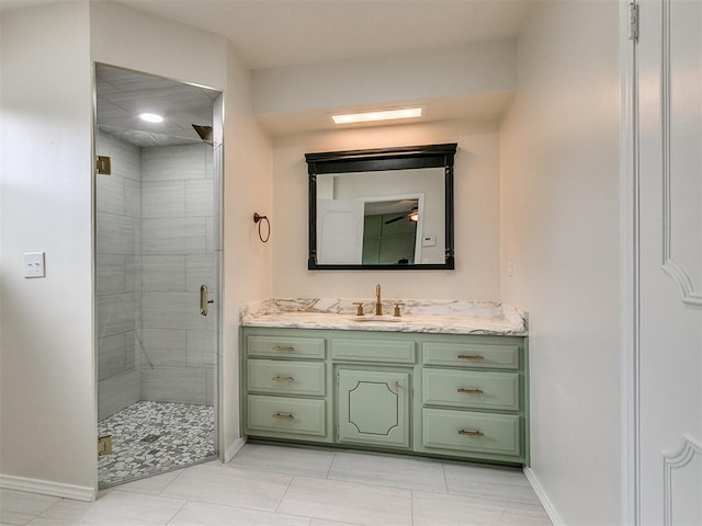 bathroom with tile patterned flooring, vanity, and walk in shower