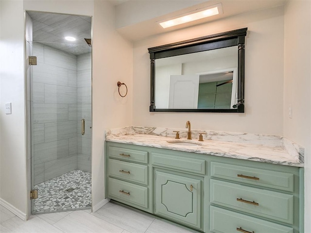 bathroom with tile patterned flooring, vanity, and walk in shower