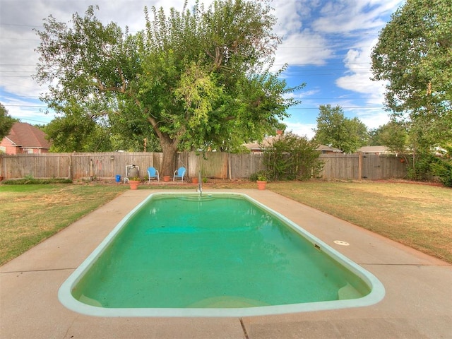 view of swimming pool with a lawn