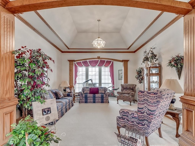 living room with carpet, a raised ceiling, ornamental molding, a notable chandelier, and beam ceiling