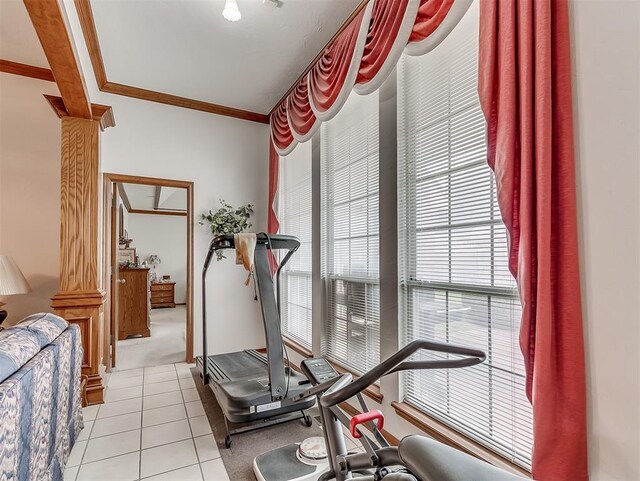 workout area with light tile patterned floors and crown molding