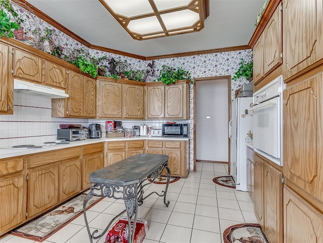 kitchen featuring tasteful backsplash, light tile patterned floors, white appliances, and ornamental molding