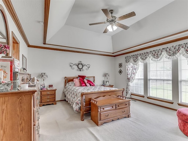 carpeted bedroom featuring a raised ceiling, multiple windows, ornamental molding, and ceiling fan