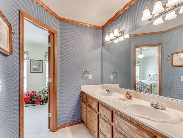 bathroom with ceiling fan, vanity, and ornamental molding