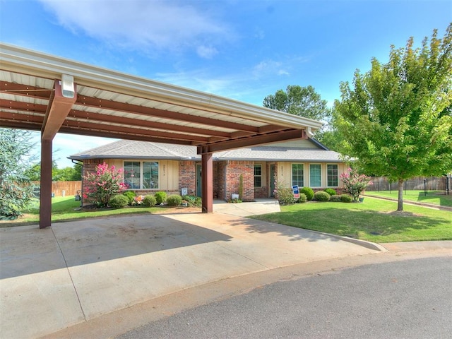 view of front of home with a front lawn and a carport