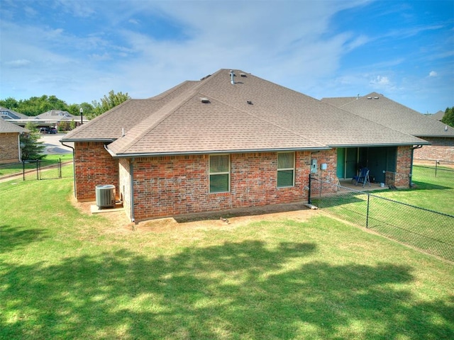 rear view of house featuring central air condition unit, a patio area, and a yard