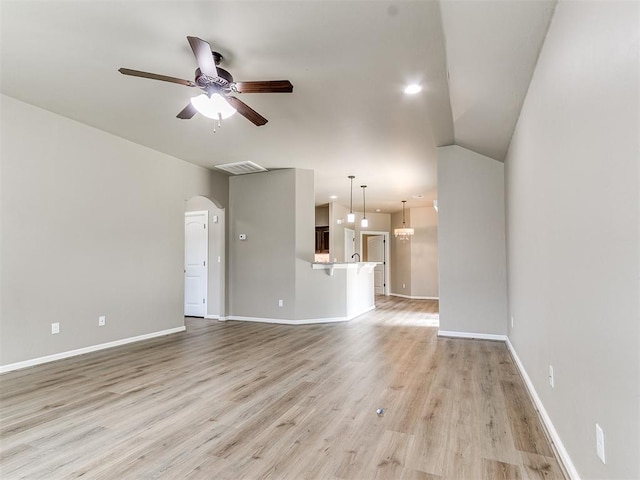 unfurnished living room featuring light hardwood / wood-style floors, vaulted ceiling, and ceiling fan