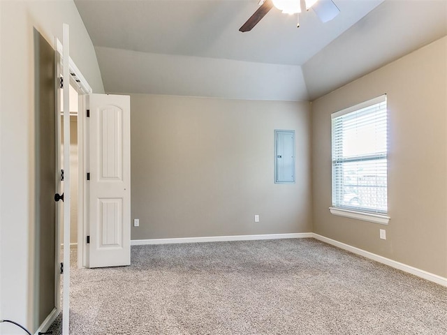 spare room with carpet flooring, electric panel, ceiling fan, and lofted ceiling