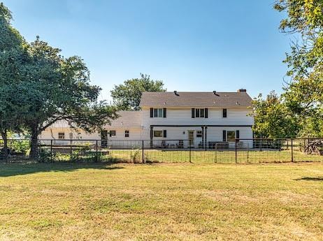 rear view of house with a lawn