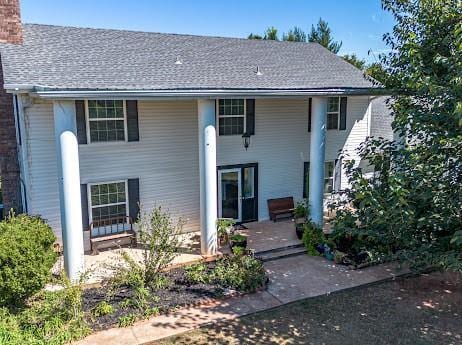10912 S Czech Hall Rd, Mustang, OK 73064 - back of house with a chimney and roof with shingles