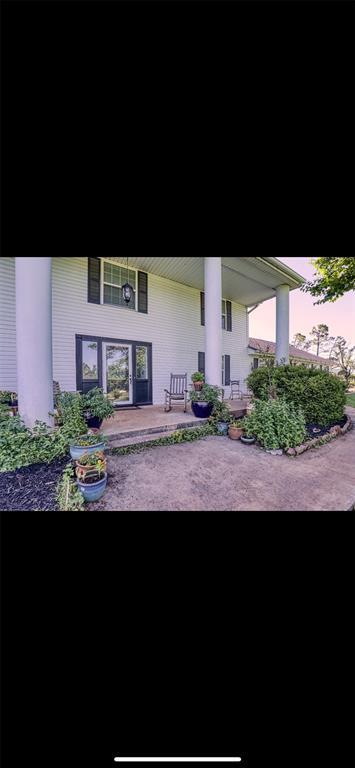 back house at dusk with a patio