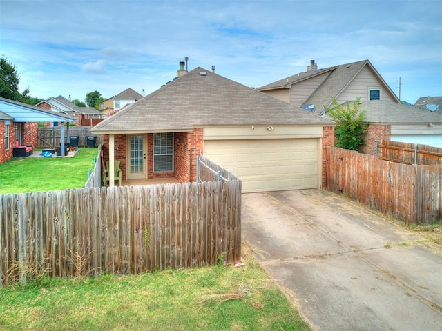 view of front of home with a front yard and a garage