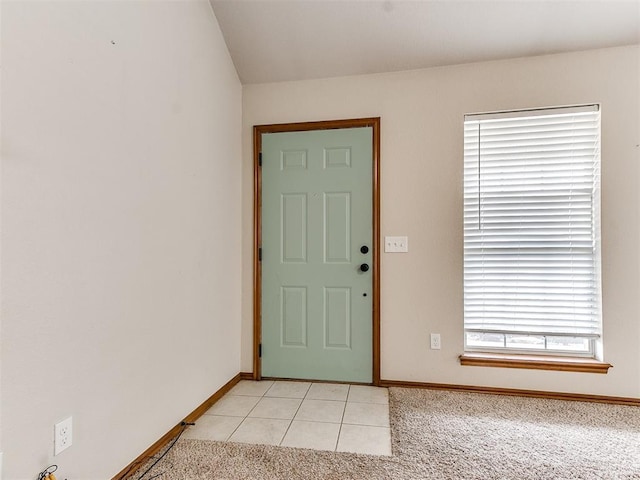 foyer entrance featuring light colored carpet and a healthy amount of sunlight