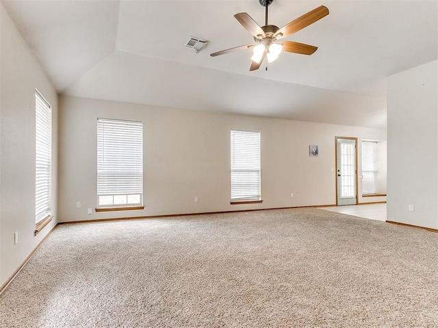 spare room with a wealth of natural light, ceiling fan, and light carpet