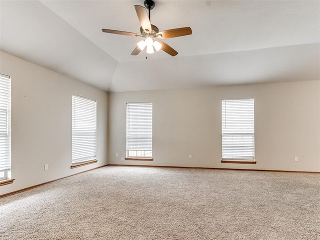 unfurnished room featuring carpet flooring, plenty of natural light, and lofted ceiling