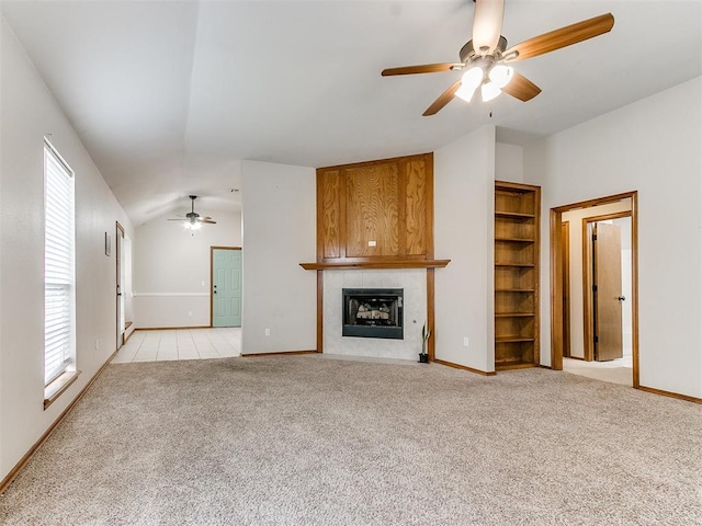 unfurnished living room with light carpet, a fireplace, and vaulted ceiling