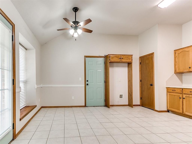 unfurnished room featuring light tile patterned floors, vaulted ceiling, and ceiling fan