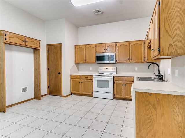 kitchen featuring light tile patterned flooring, white electric range, and sink