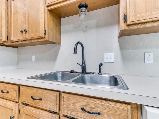 kitchen with light brown cabinetry and sink